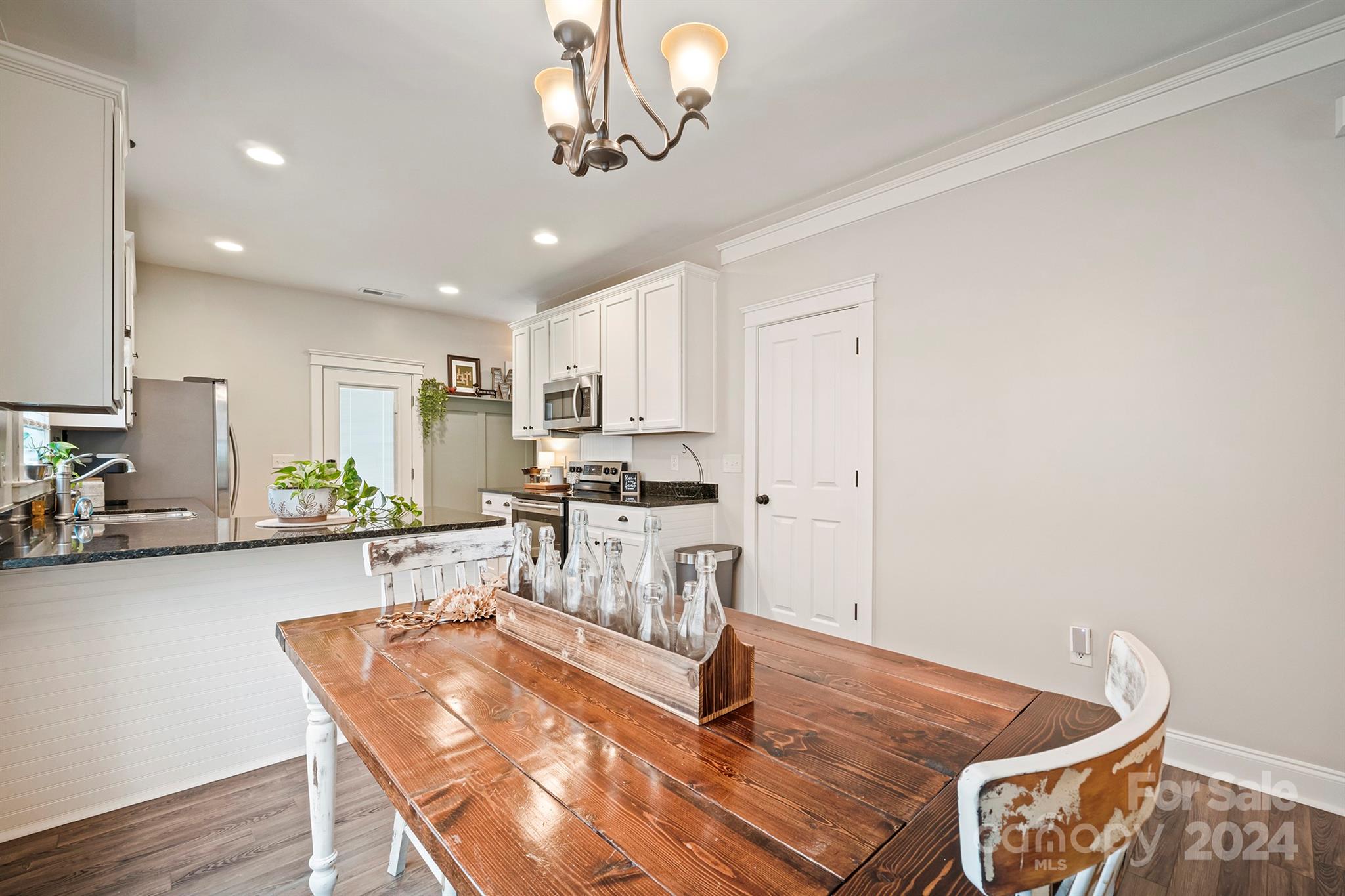 13516 Stumptown Road Huntersville, NC 28078 - Photo 10 of 37 a living room with stainless steel appliances furniture a dining table and chairs with wooden floor