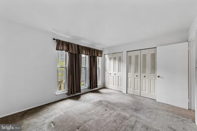 a view of an empty room with closet area