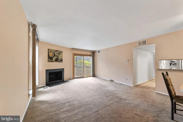 a view of empty room with a fireplace