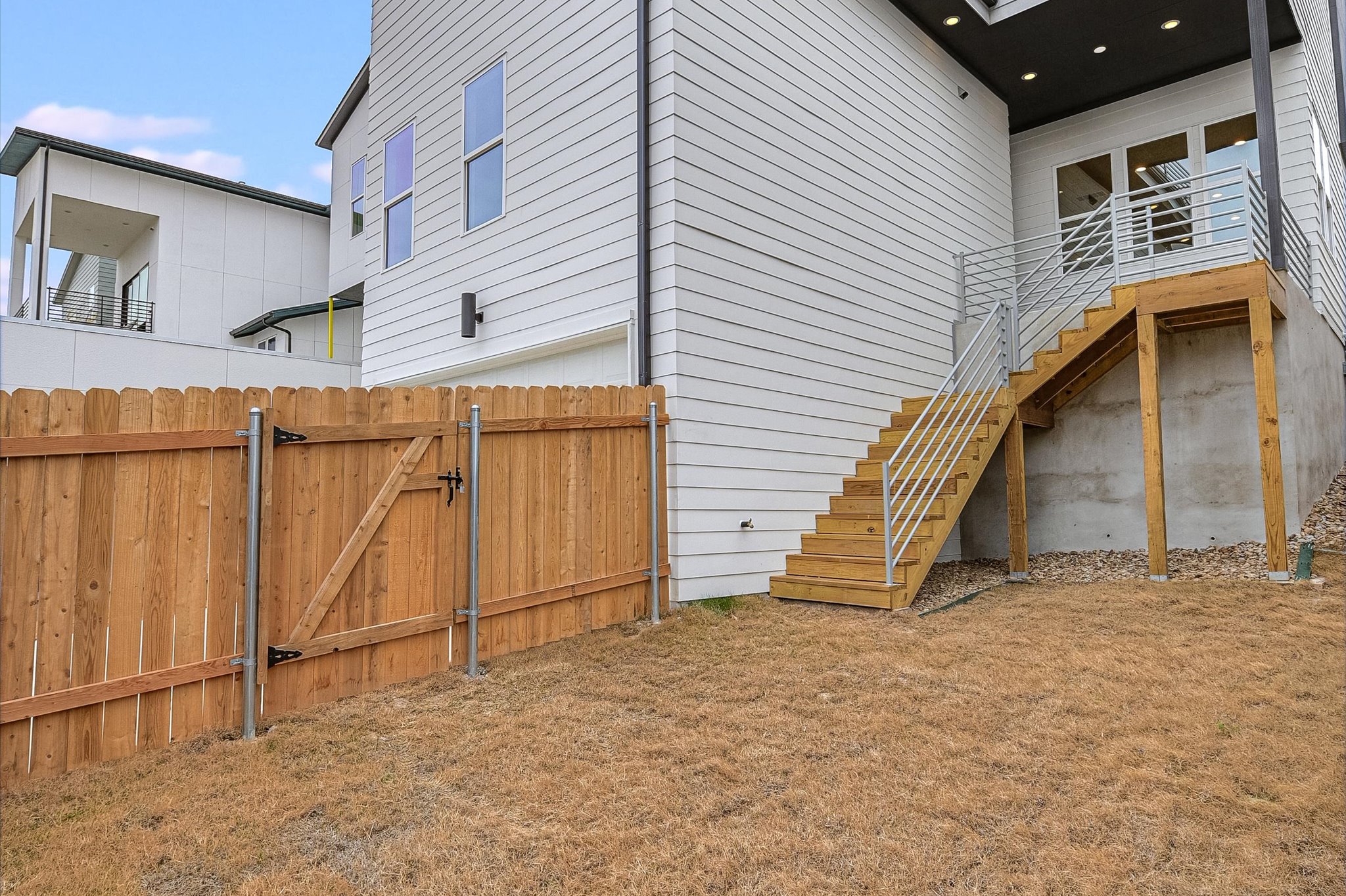 6136 Florencia Lane Austin, TX 78724 - Photo 24 of 40 View of side of property featuring a gate and stairway