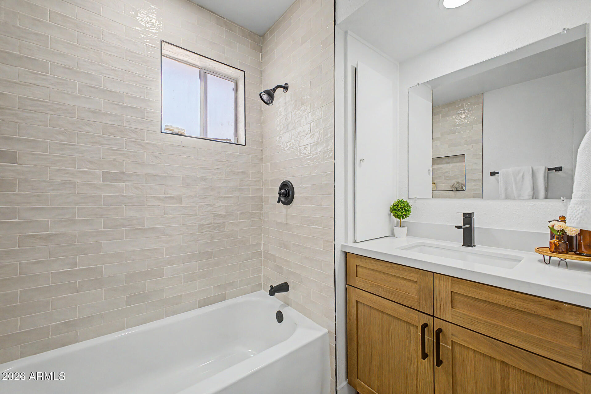 1531 West Colter Street, Unit 1 Phoenix, AZ 85015 - Photo 12 of 22 a white bath tub sitting next to a bathroom sink