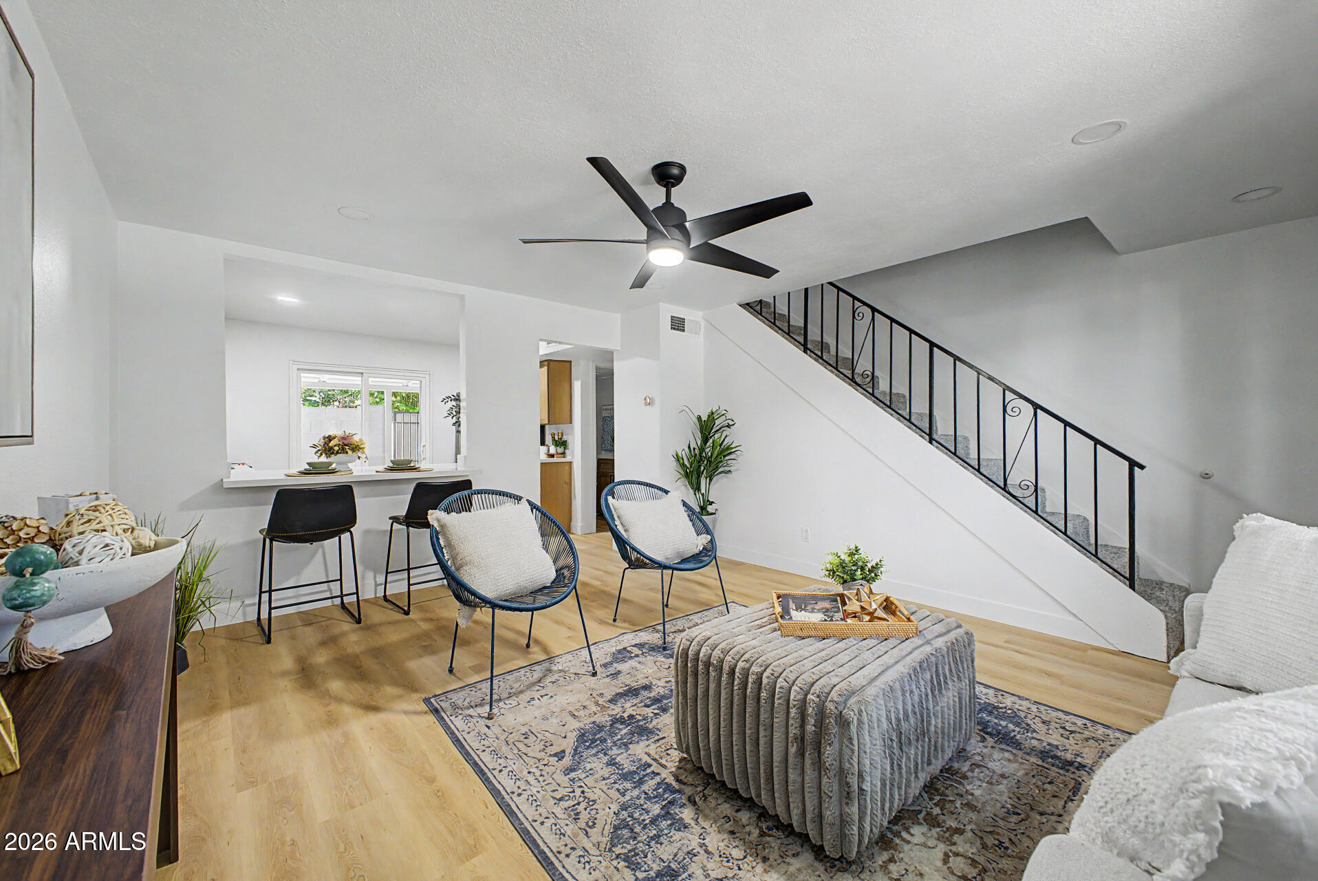 1531 West Colter Street, Unit 1 Phoenix, AZ 85015 - Photo 2 of 22 a living room with furniture a rug and white walls