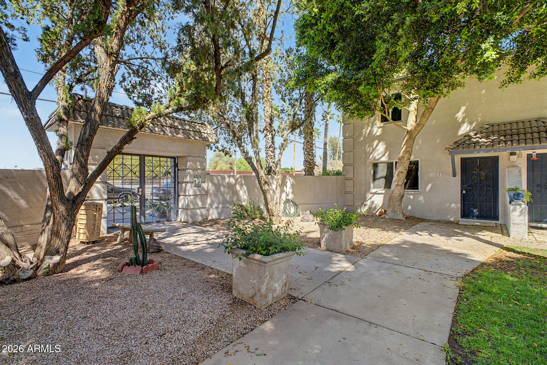 1531 West Colter Street, Unit 1 Phoenix, AZ 85015 - Photo 21 of 22 a view of a street with potted plants and large trees