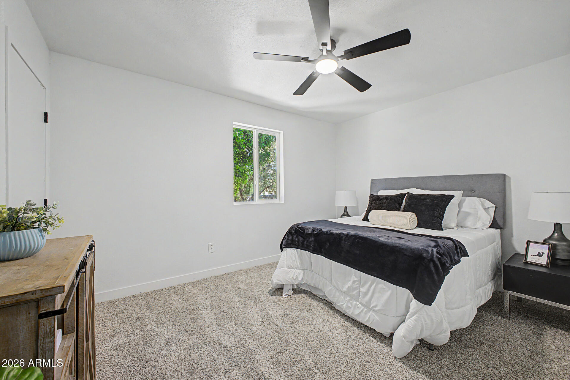 1531 West Colter Street, Unit 1 Phoenix, AZ 85015 - Photo 8 of 22 a spacious bedroom with a bed and a chandelier