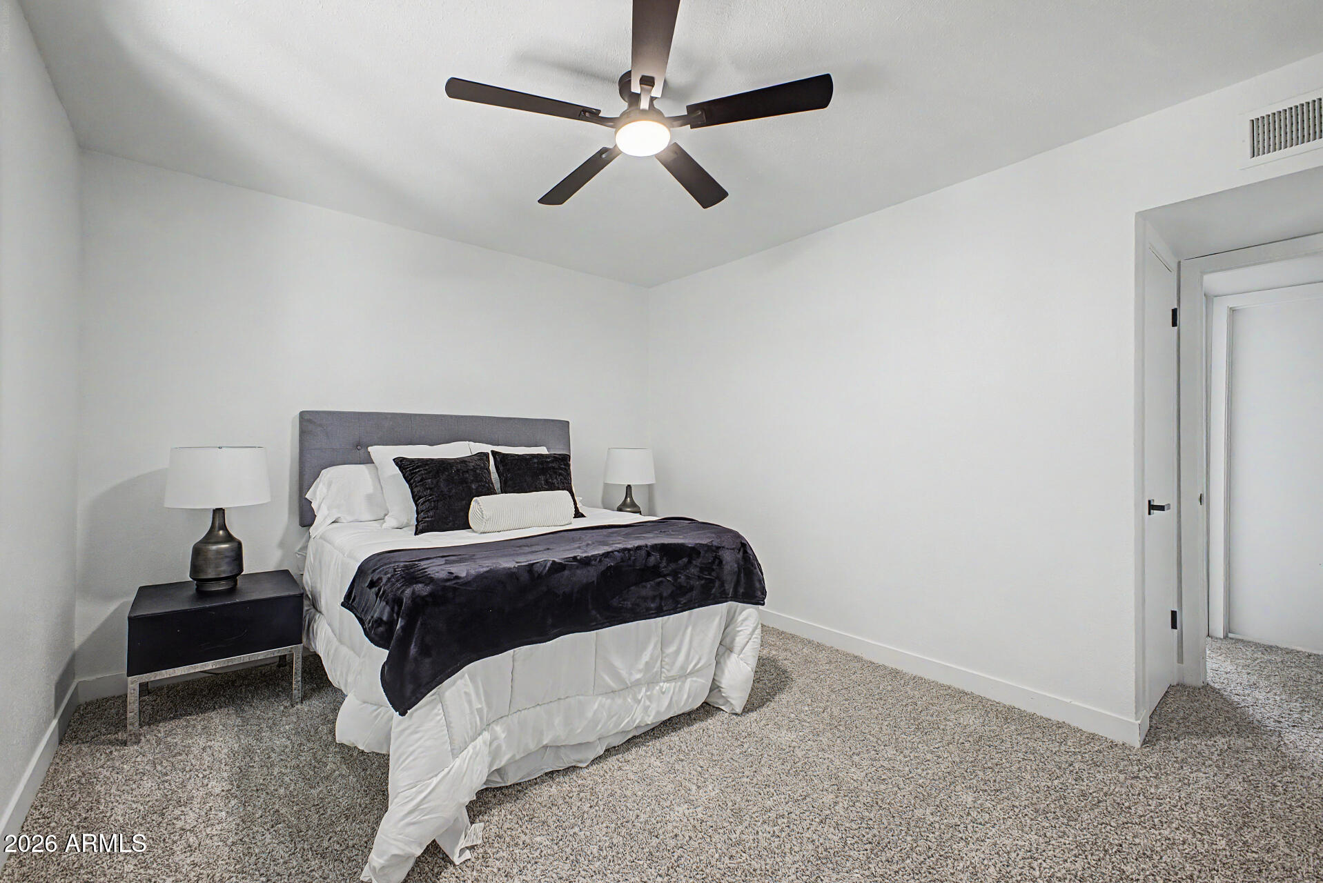 1531 West Colter Street, Unit 1 Phoenix, AZ 85015 - Photo 9 of 22 a bedroom with a bed and a ceiling fan