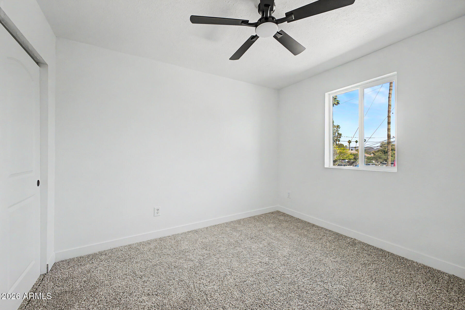 1531 West Colter Street, Unit 1 Phoenix, AZ 85015 - Photo 10 of 22 an empty room with a window and a fan