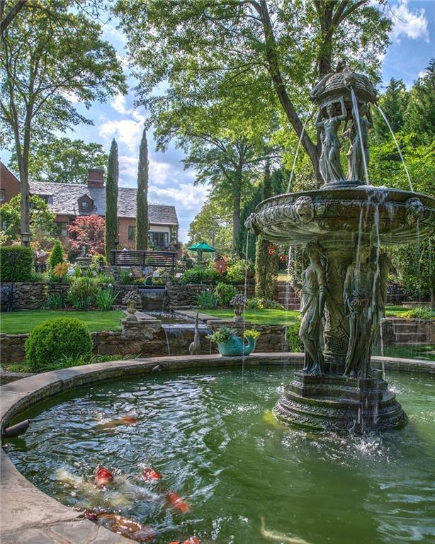 1.Rear of property boasts an antique Italian fountain and Koi pond with self feeding system. Stone terraced walls where exposed when excavating and restoring the gardens.