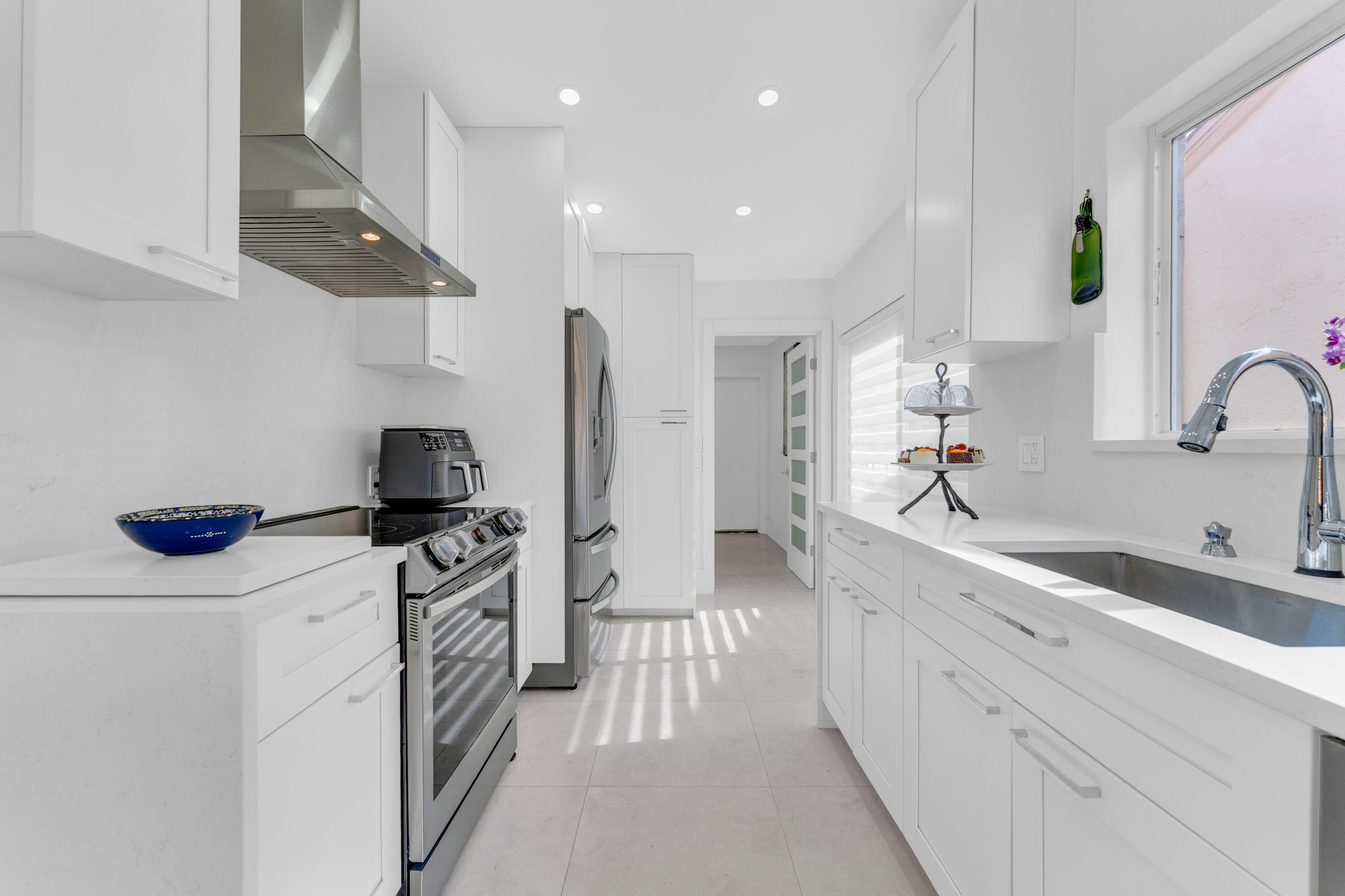 8024 Copenhagen Way Boca Raton, FL 33434 - Photo 22 of 69 a kitchen with stainless steel appliances a sink stove and refrigerator