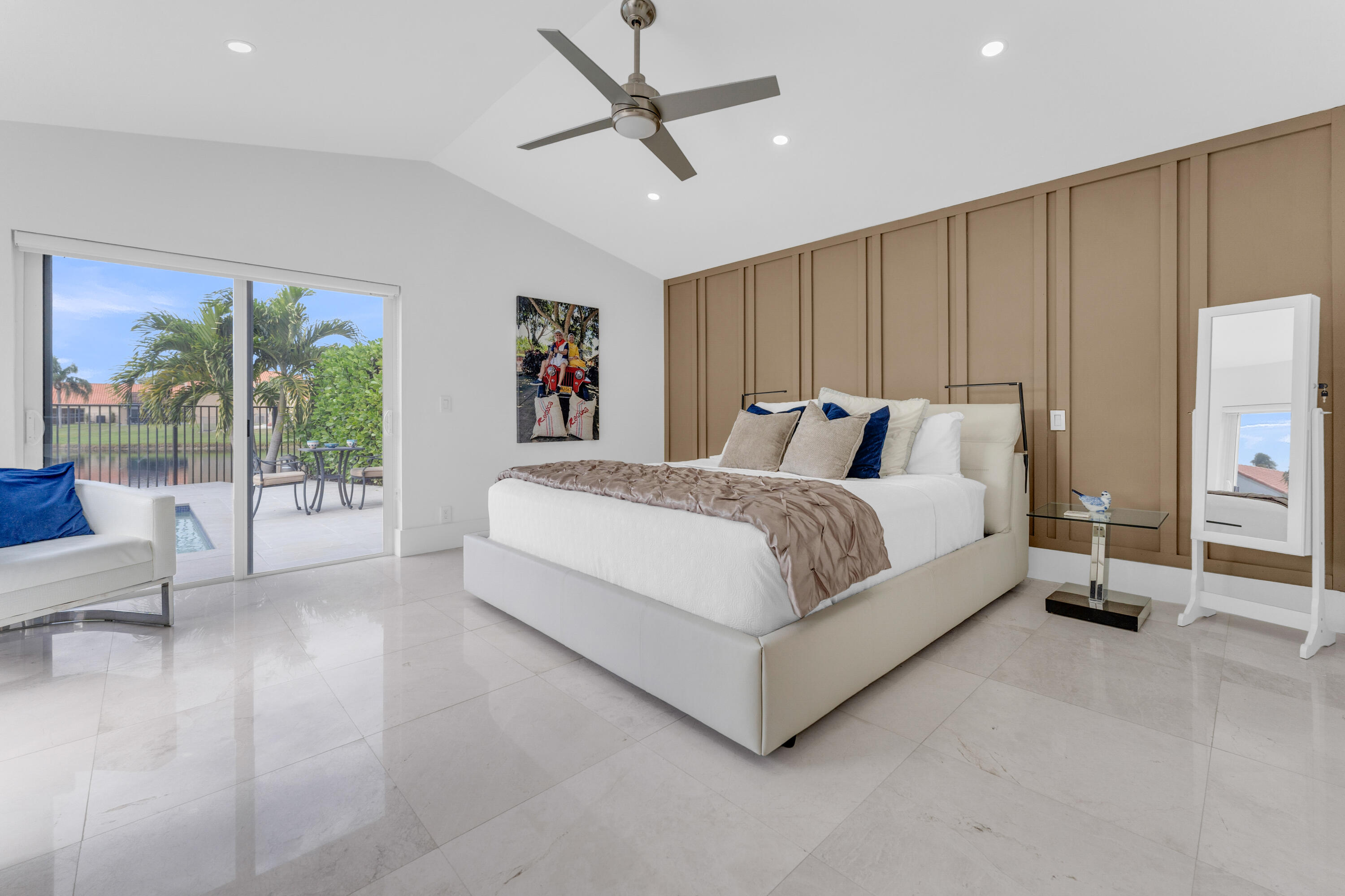 8024 Copenhagen Way Boca Raton, FL 33434 - Photo 28 of 69 a bedroom with a large bed and a chandelier