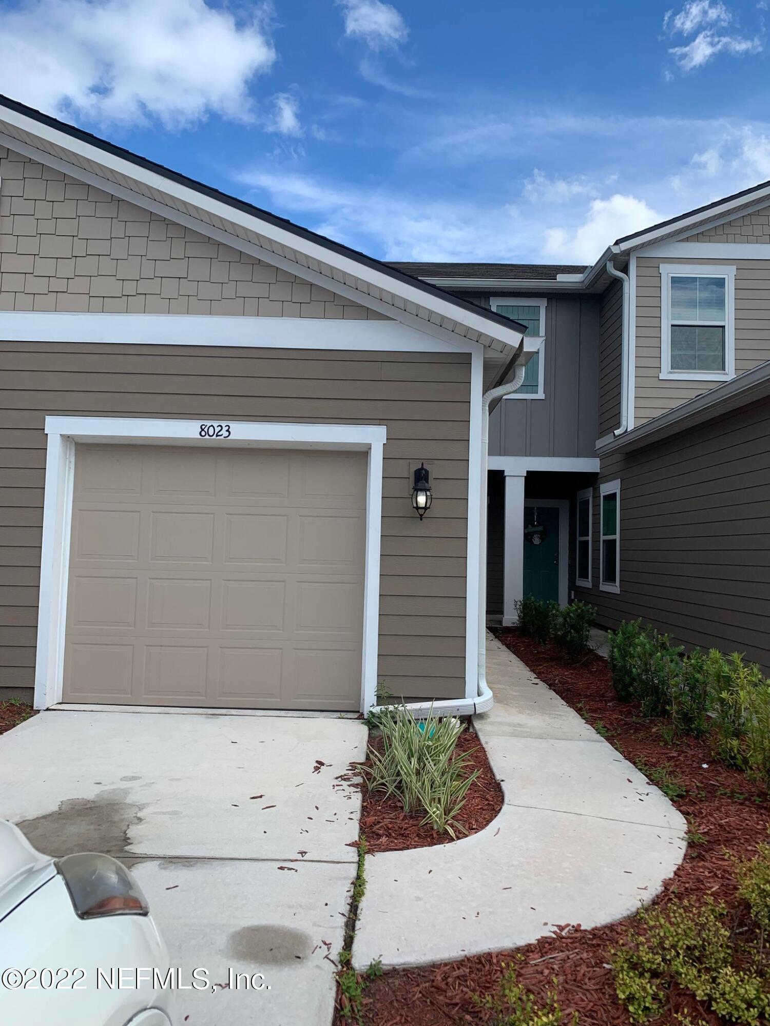 8023 Echo Springs Road Jacksonville, FL 32256 - Photo 1 of 9 a front view of a house with garden