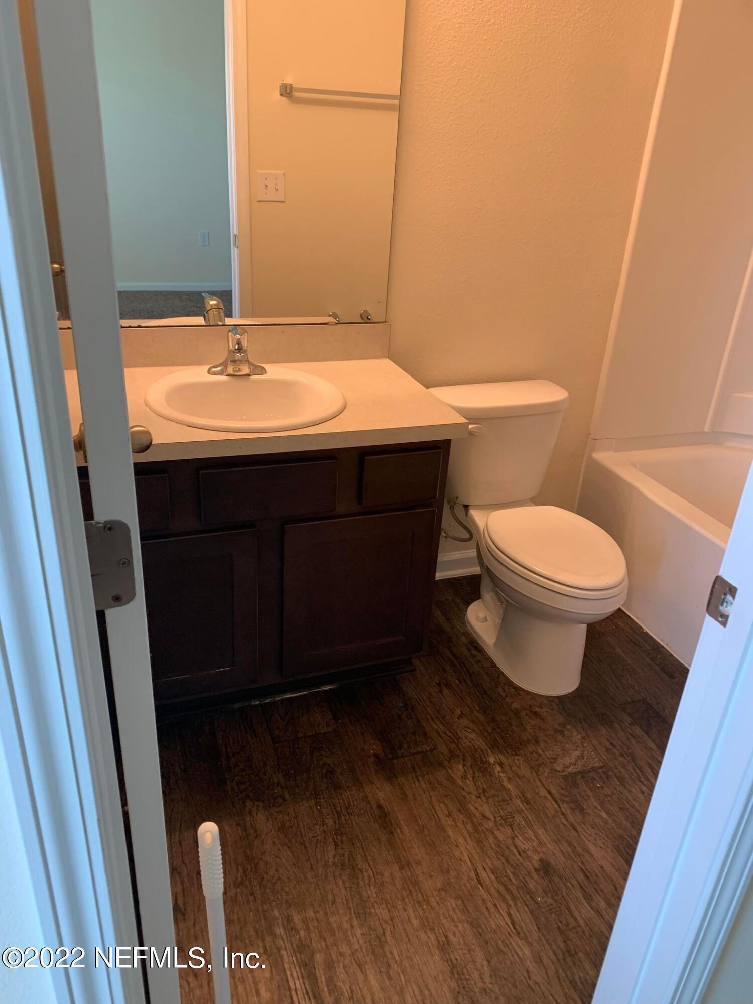 8023 Echo Springs Road Jacksonville, FL 32256 - Photo 7 of 9 a bathroom with a sink and a toilet