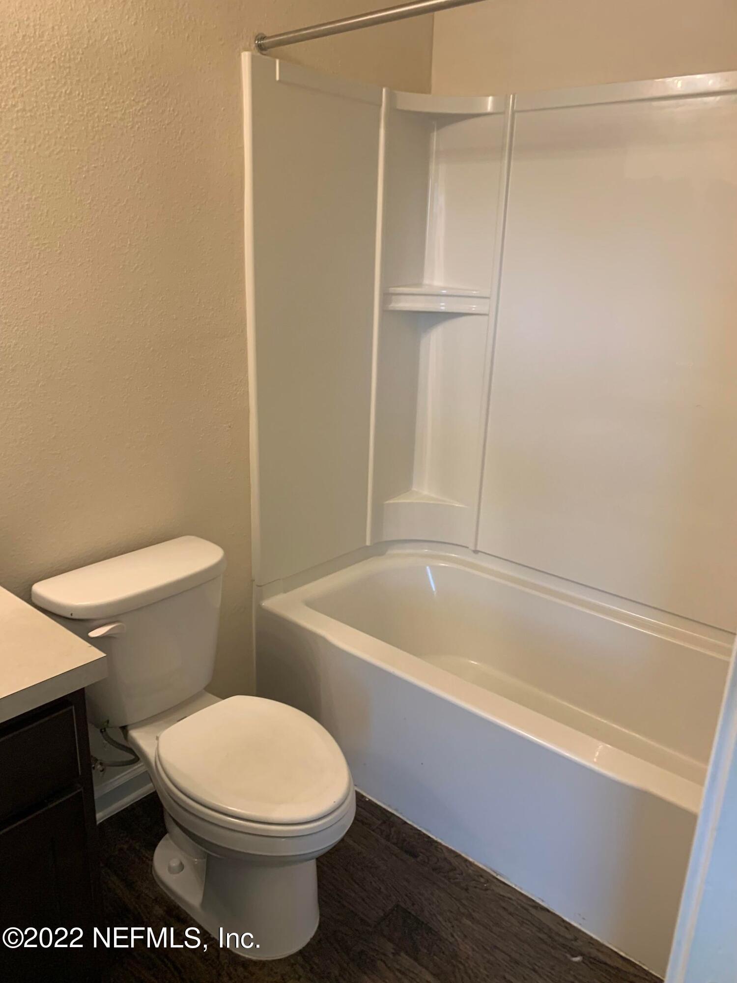 8023 Echo Springs Road Jacksonville, FL 32256 - Photo 8 of 9 a white toilet sitting next to a bath tub