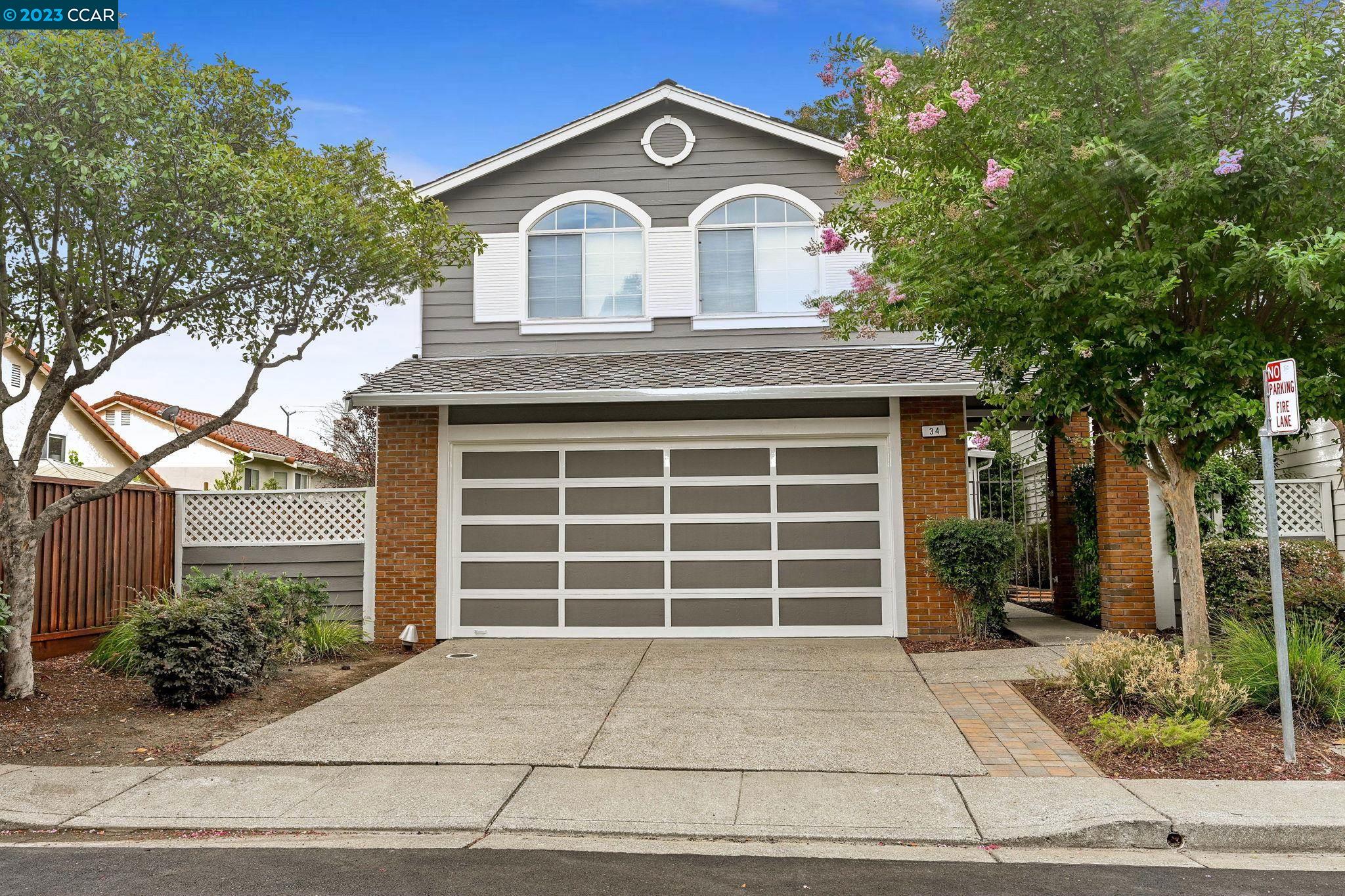 34 Winterwind Court San Ramon, CA 94583 - Photo 1 of 1 a front view of a house with a yard and garage