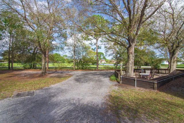 a view of house with yard and sitting area