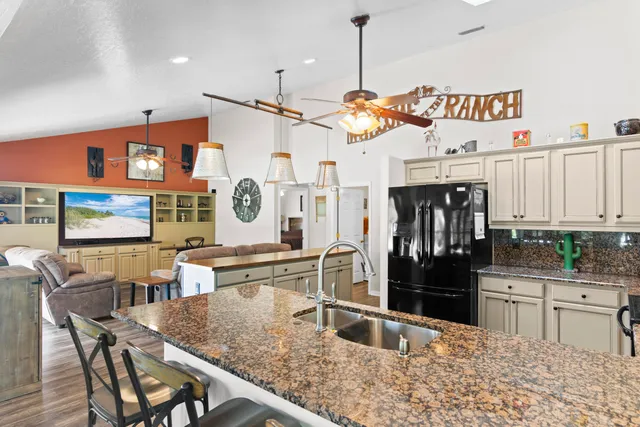 a kitchen with a sink a counter and chairs