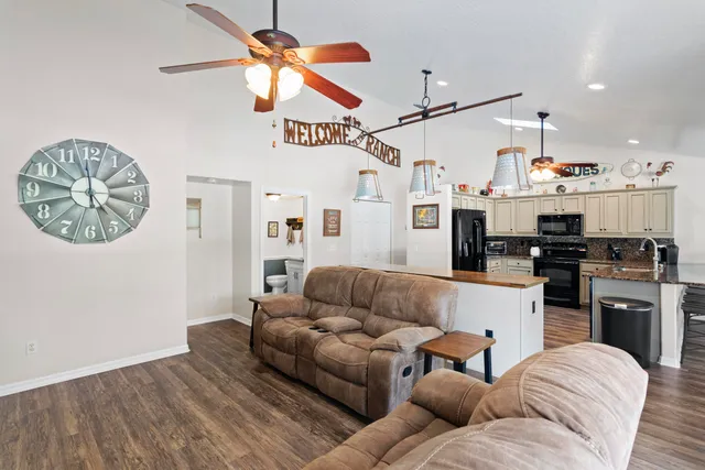 a living room with furniture a window and a clock