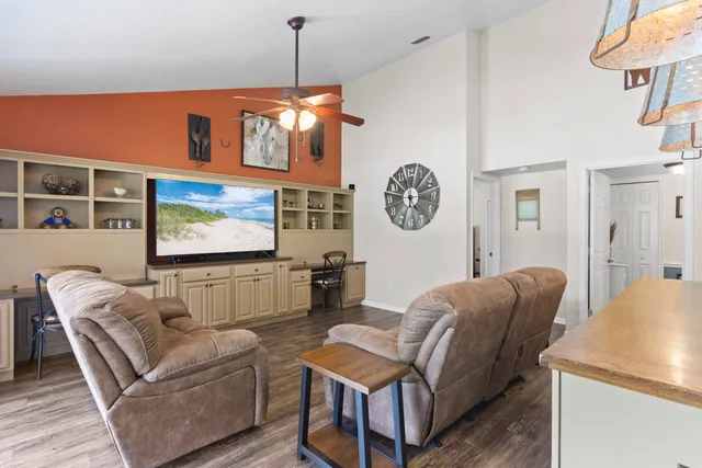 a room with pool table and windows