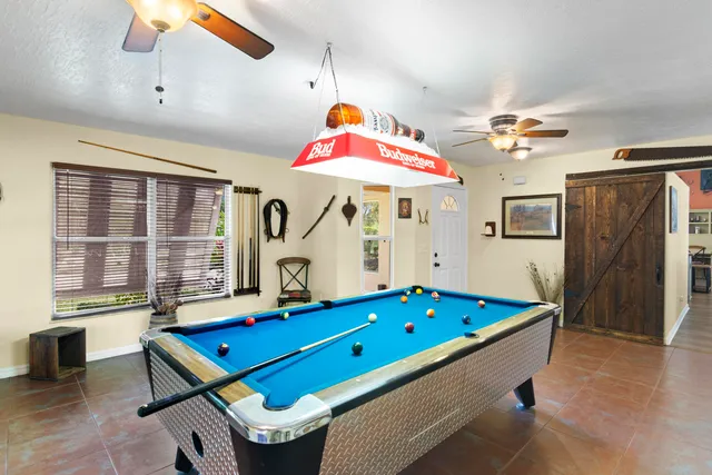 a bedroom with a bed and a desk with stool