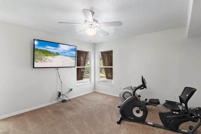 a bathroom with a granite countertop toilet a sink and a mirror