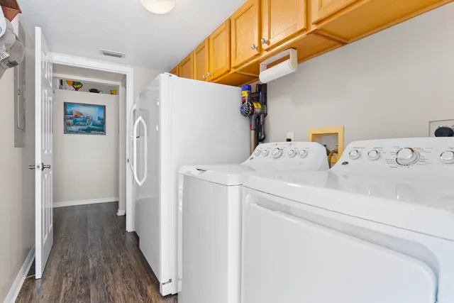 a kitchen with stainless steel appliances granite countertop a kitchen island hardwood floor sink and dining table