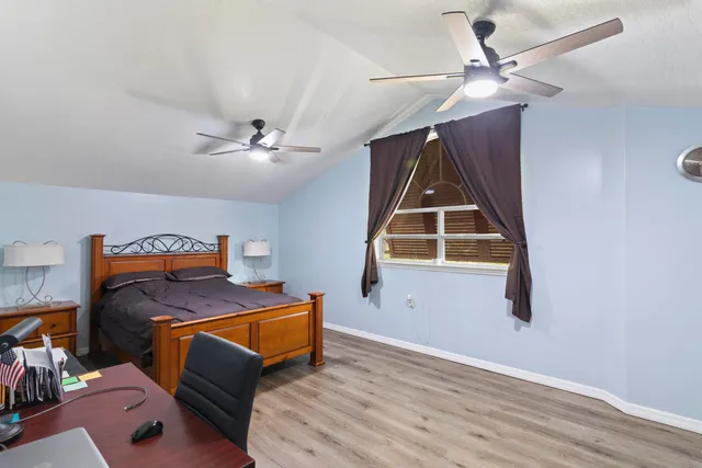 a bathroom with a sink a toilet and shower curtain