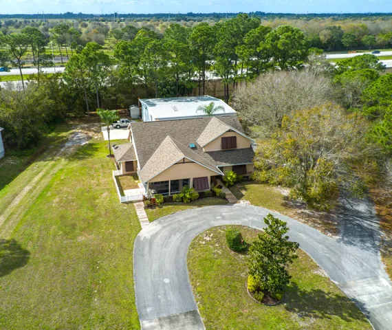 an aerial view of a house with a yard