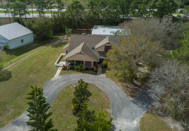 an aerial view of a house with a yard