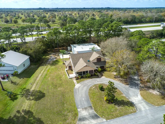 an aerial view of a house with a yard