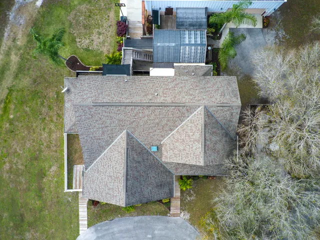 a view of a house with swimming pool and a yard