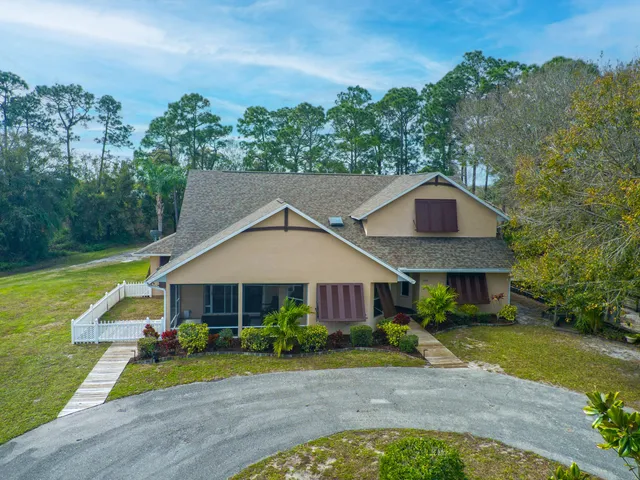 a front view of a house with swimming pool having outdoor seating