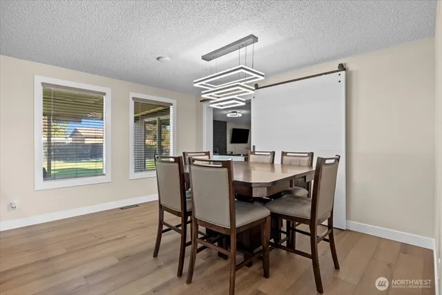 a view of a dining room with furniture window and wooden floor