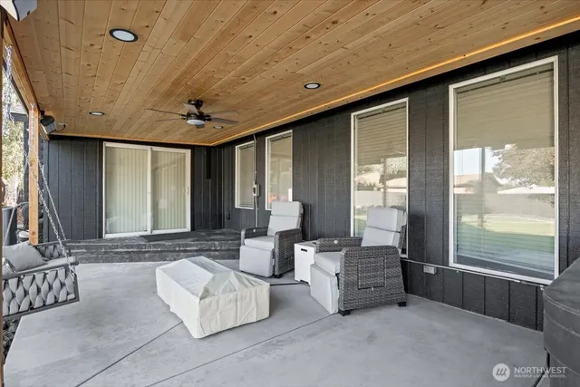 a view of a house with a big yard and large trees