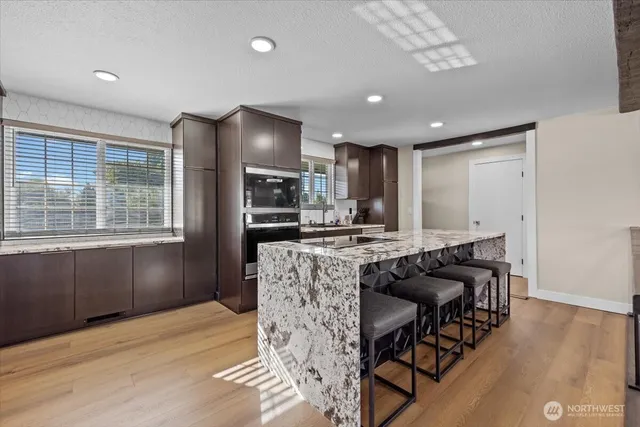 a kitchen with a wooden floor and a window