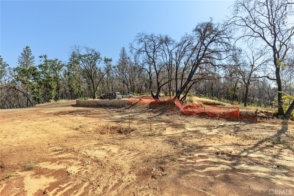 105 Harvey Road Chico, CA 95973 - Photo 5 of 16 a backyard of a house with large trees and outdoor seating