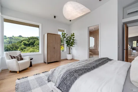 a bedroom with a large bed and a window