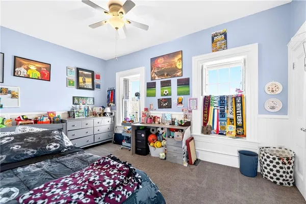 a bedroom with bed and a chandelier