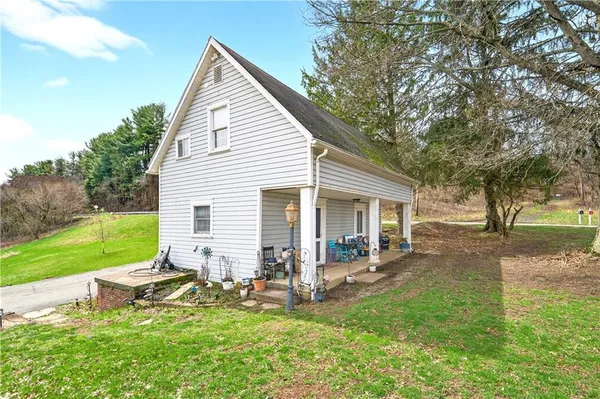 a view of a house with backyard and sitting area