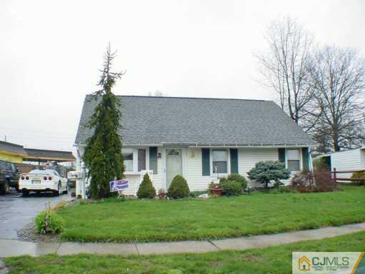 136 Idlewild Road Edison, NJ 08817 - Photo 2 of 2 a front view of a house with a garden and trees
