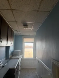 a kitchen with a sink a stove and cabinets