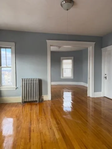 wooden floor in a hall with a window