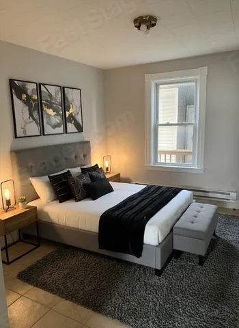 a bedroom with a bed and a window