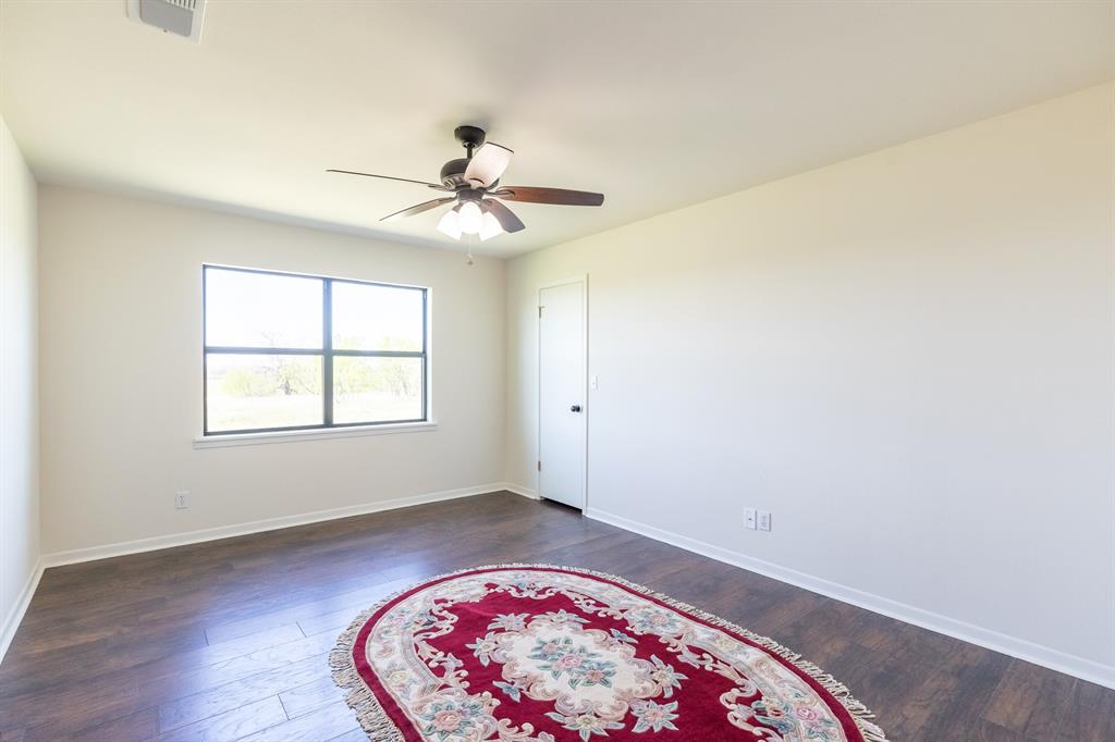 642 Fm 3200 Comanche, TX 76442 - Photo 21 of 37 wooden floor in an empty room with a window