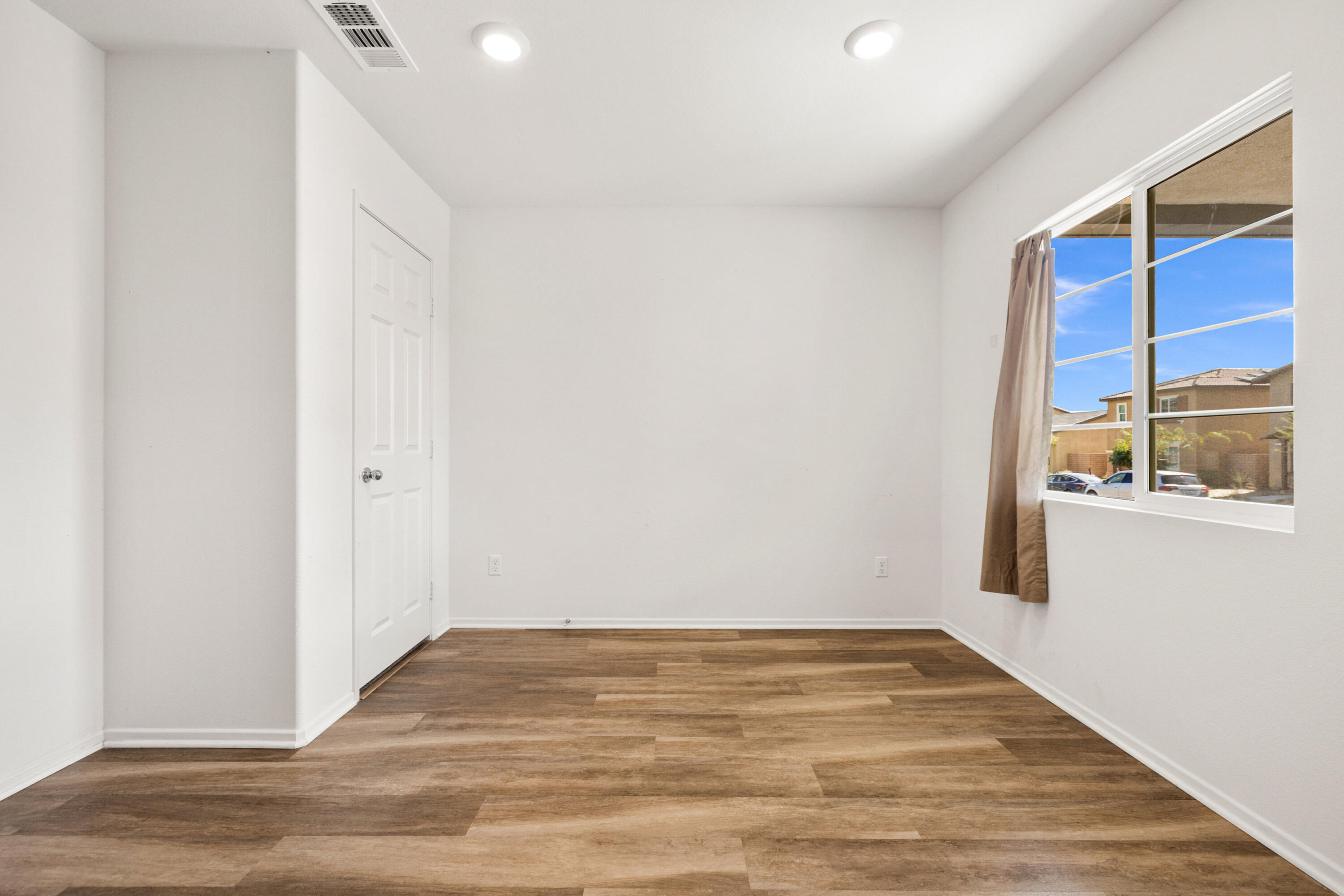 67364 Rio Plata Road Cathedral City, CA 92234 - Photo 14 of 49 a view of empty room with wooden floor and fan