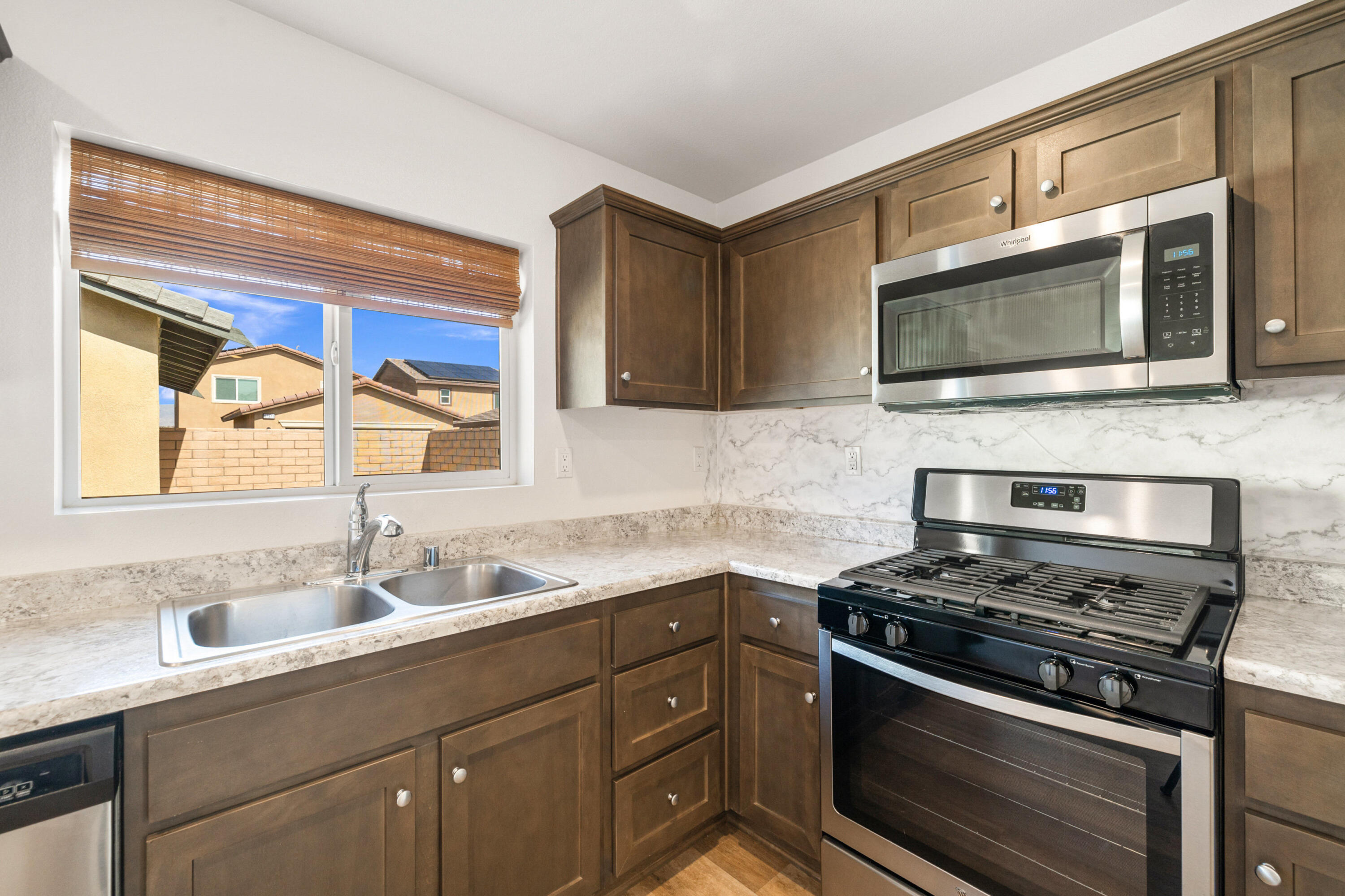 67364 Rio Plata Road Cathedral City, CA 92234 - Photo 17 of 49 a kitchen with stainless steel appliances a stove microwave and sink