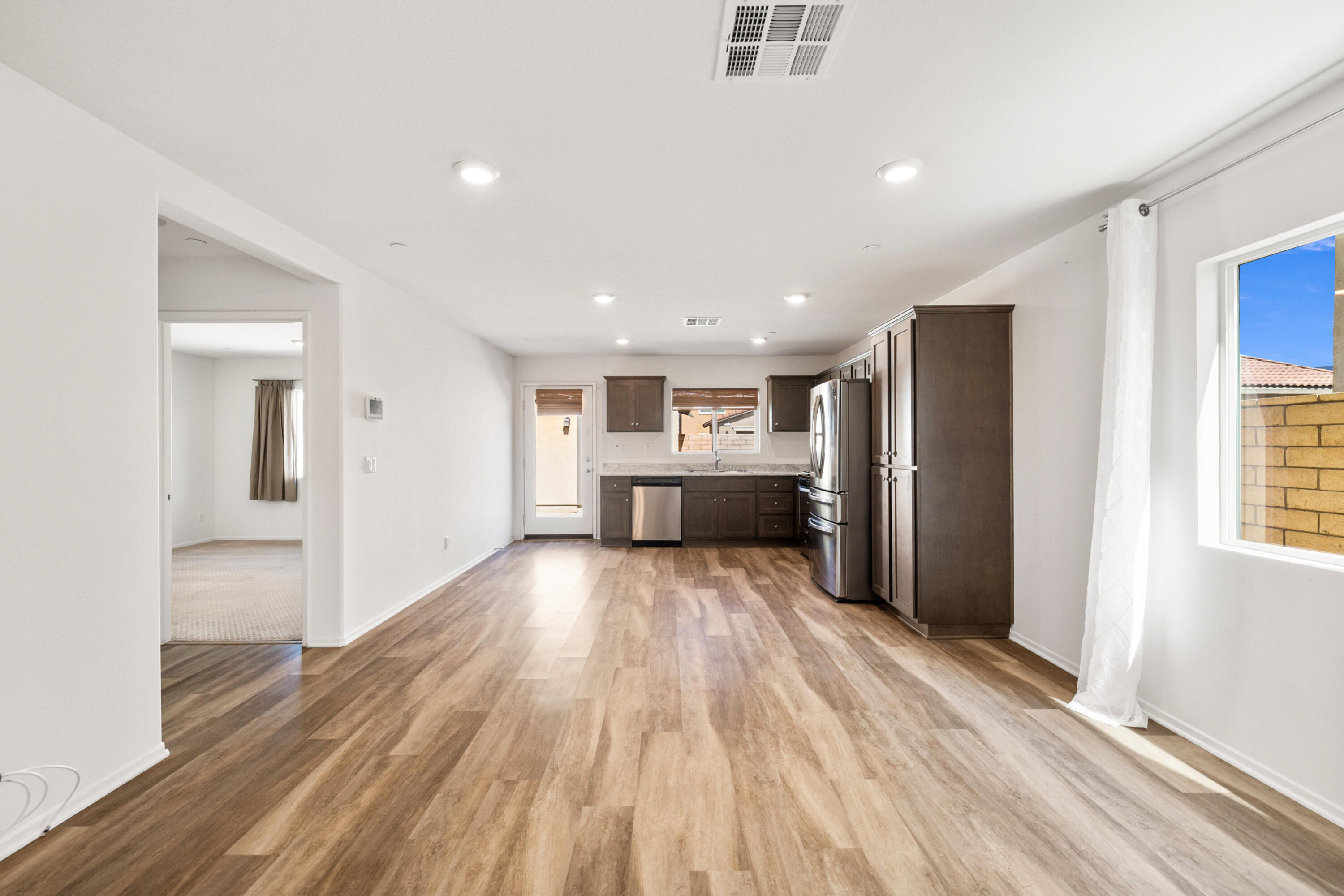 67364 Rio Plata Road Cathedral City, CA 92234 - Photo 18 of 49 a view of kitchen with refrigerator stove and wooden floor