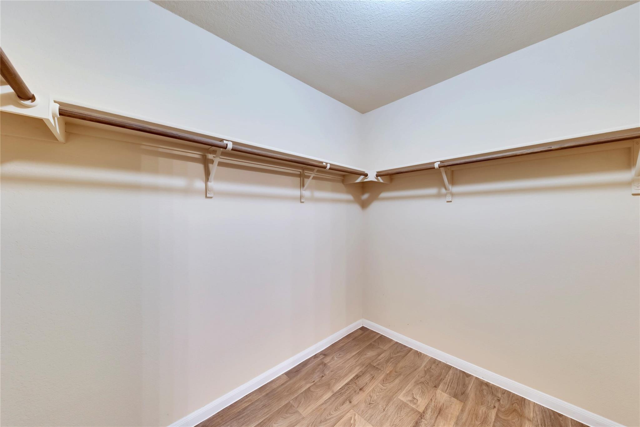 5913 Diamondleaf Bend Austin, TX 78724 - Photo 14 of 20 Spacious walk-in closet featuring extensive built-in shelving and hanging rods