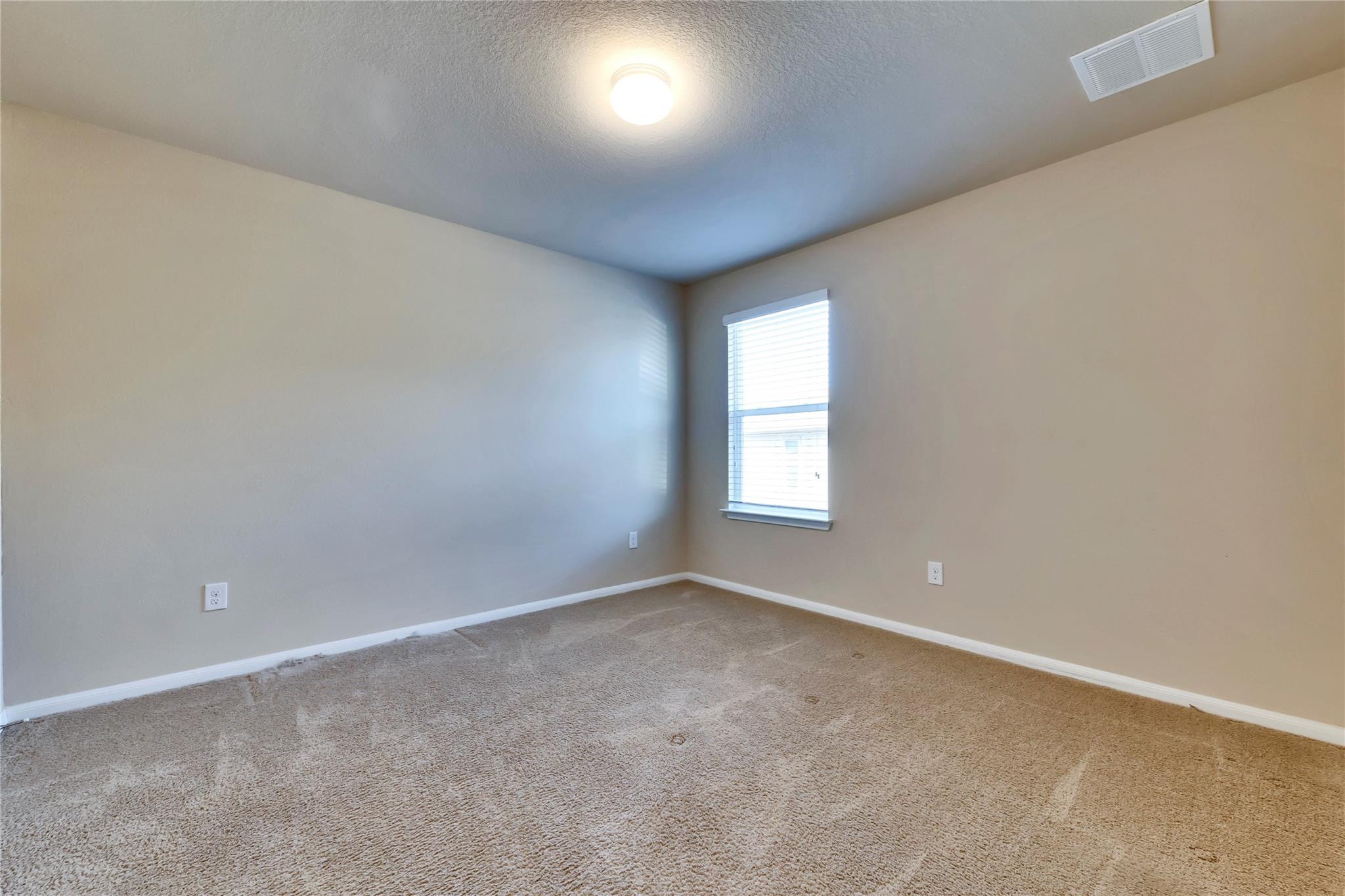 5913 Diamondleaf Bend Austin, TX 78724 - Photo 9 of 20 Carpeted room with neutral wall paint and white trim