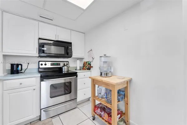 a kitchen with stainless steel appliances a stove a microwave sink and cabinets