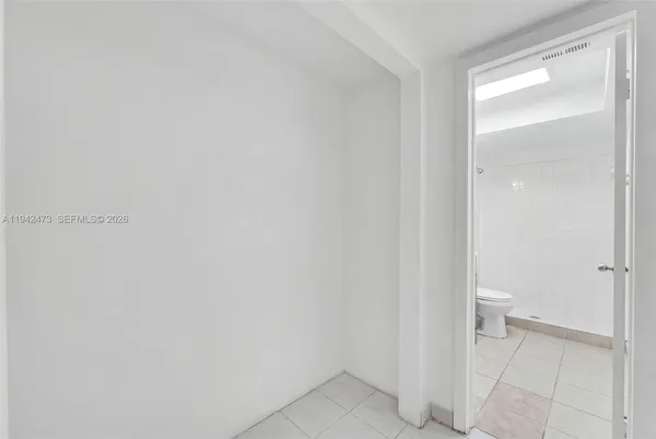 a bathroom with a toilet sink vanity and mirror