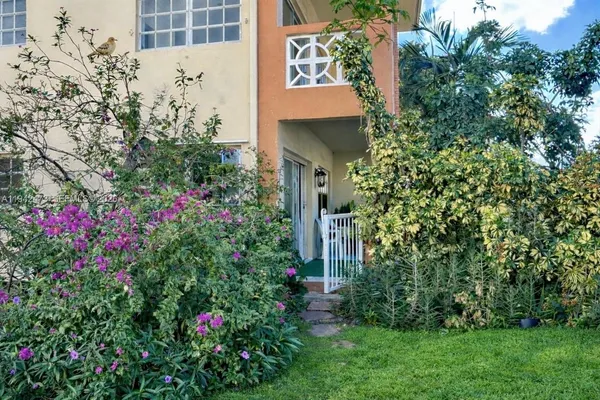 a view of a house with a flower garden